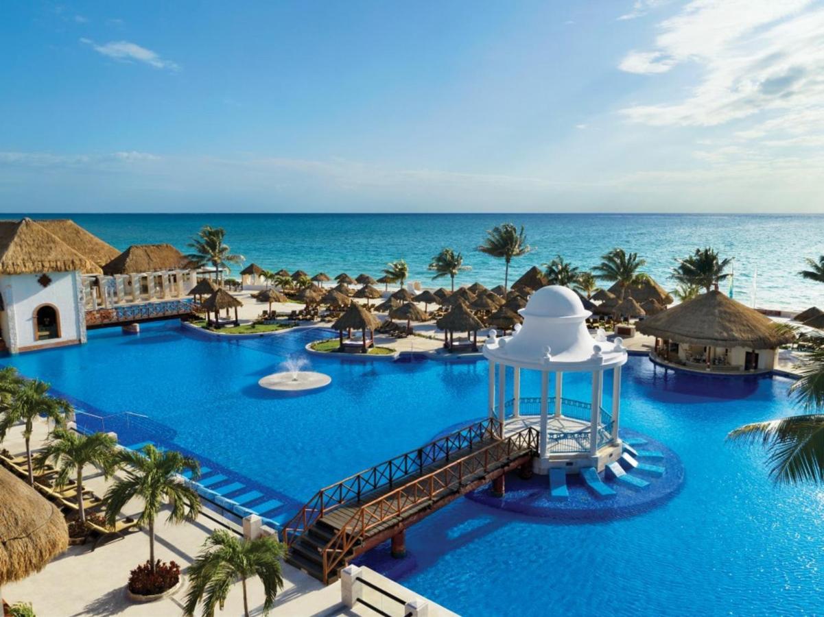 The large pool and beach at a resort in Mexico. 