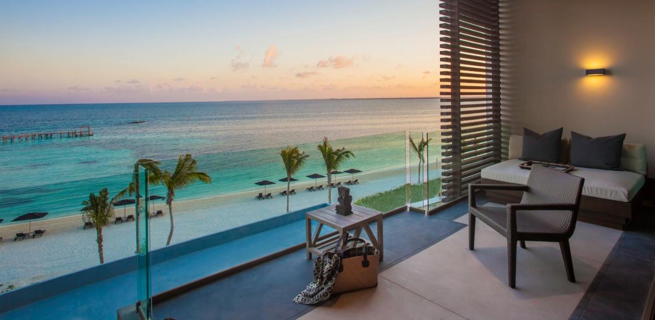 A terrace that has lounger seating that overlooks a Mexican beach. 