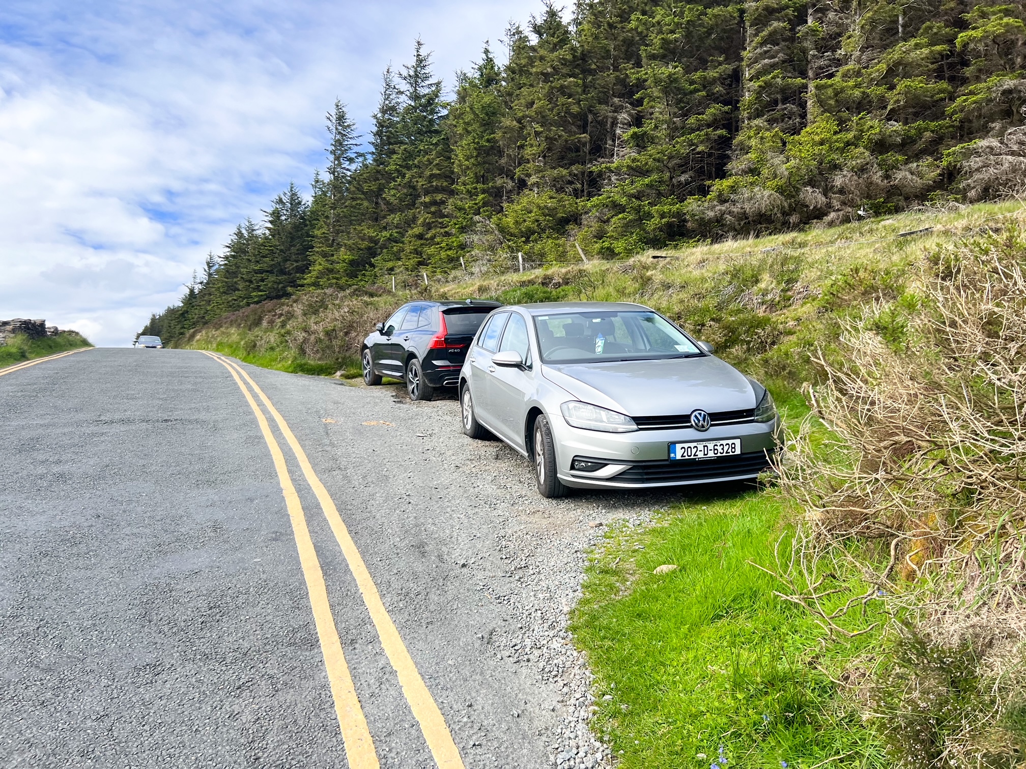 two cars parked along the Ballinastoe Woods walking trail in ireland 