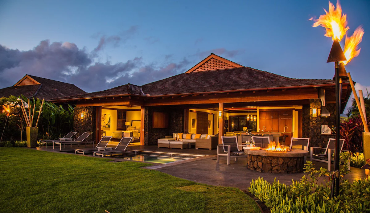 hotel cabin with lounge and bedroom area and firepit outside. 