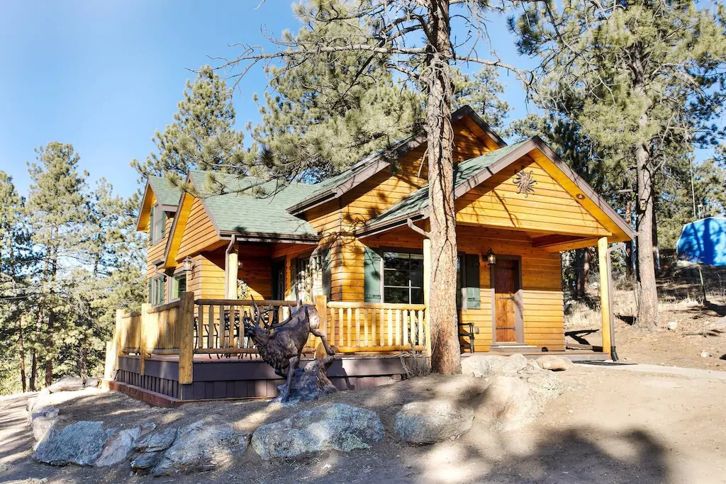 One of the best cabins in Colorado. the picture shows a log cabin surrounded by trees.  