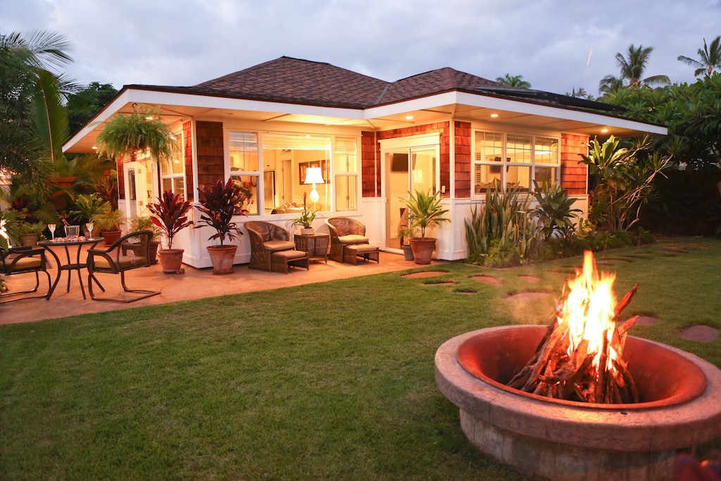 view of the firepit and beautiful exterior of the cottage paradise