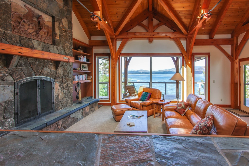 View of the amazing vaulted cedar ceiling living room for of this lakeside cabin in idaho