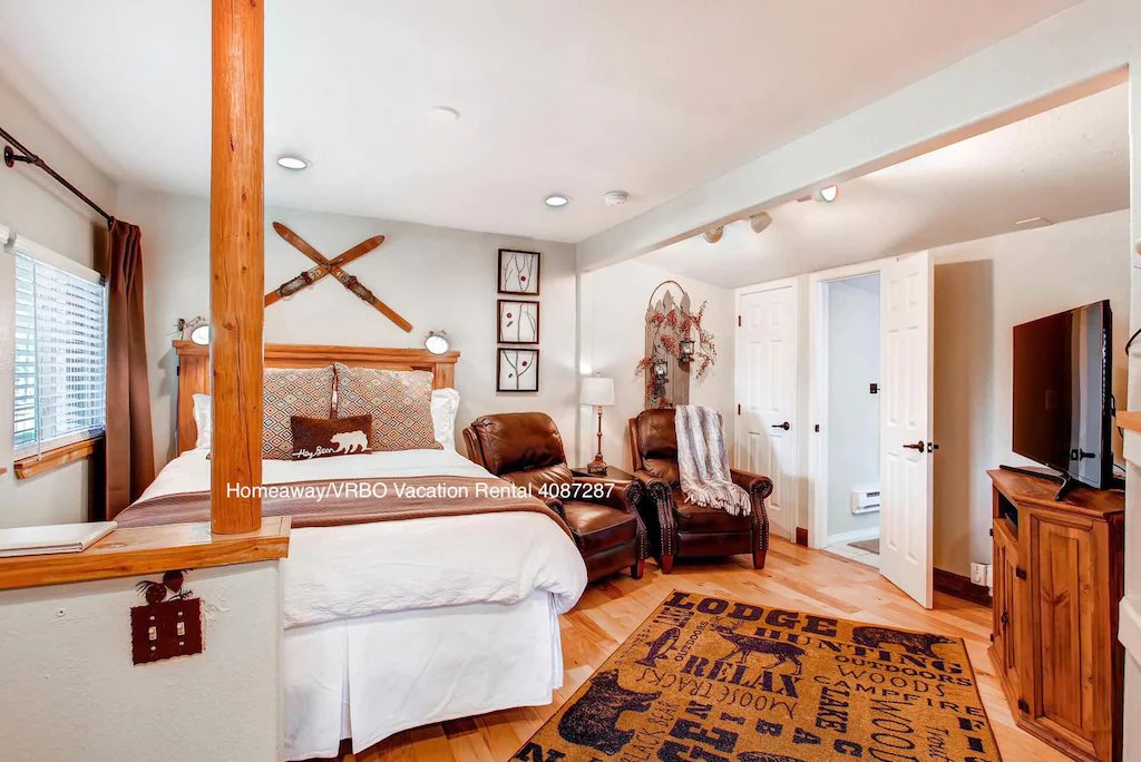 Room inside a romantic cabin in Colorado. Its all white and brown with a fresh clean look. 