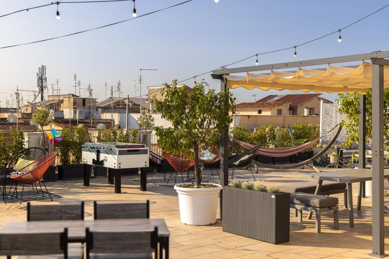 Rooftop terrace with lots of chairs, table, a hammock, and game table.