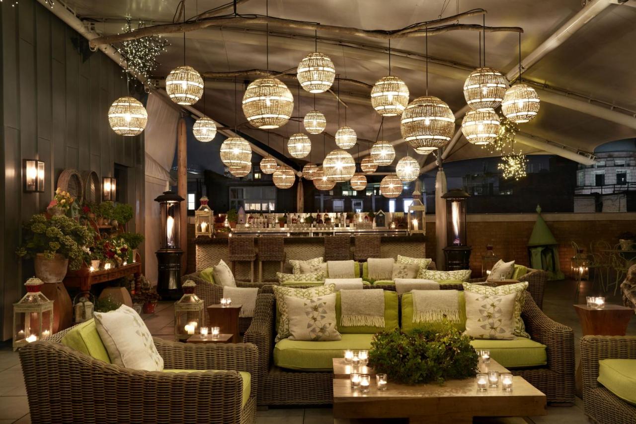 Beautiful rooftop terrace at night with bar in the background.