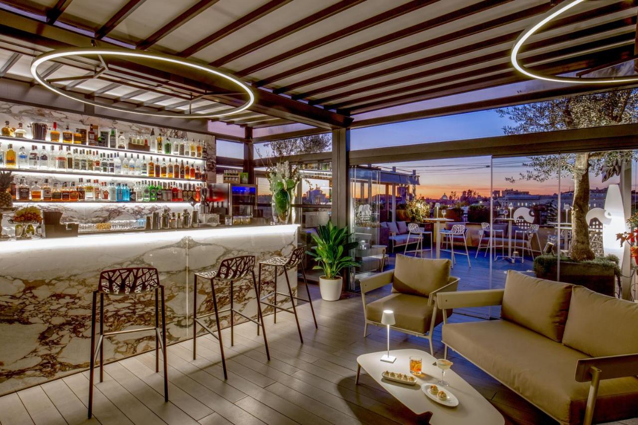 Modern bar area leading to a balcony at sunset.