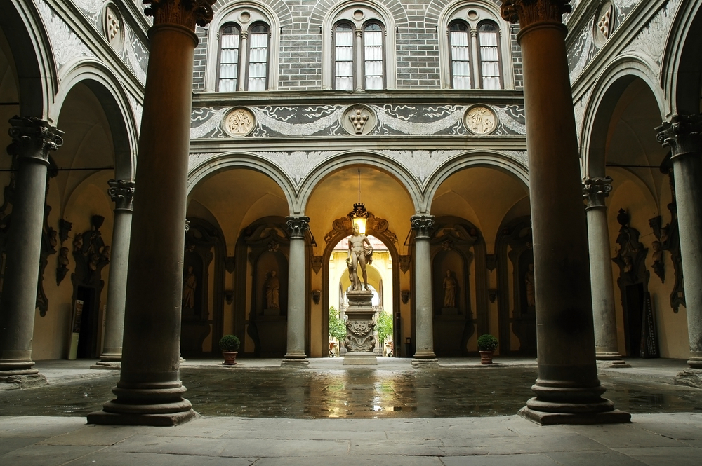 The inner courtyard of Palazzo Medici with a statue.