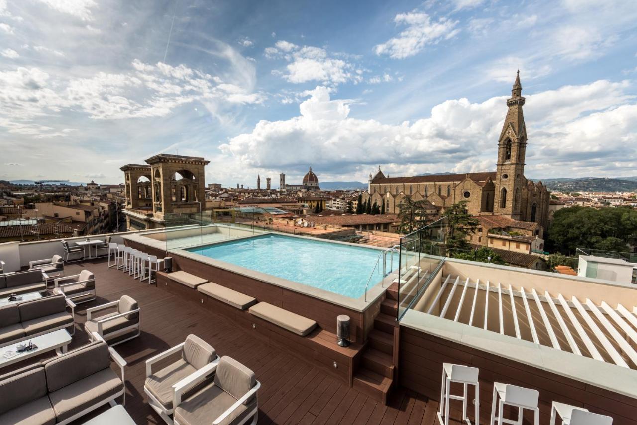 Rooftop pool and lounge area with panoramic views of the city.