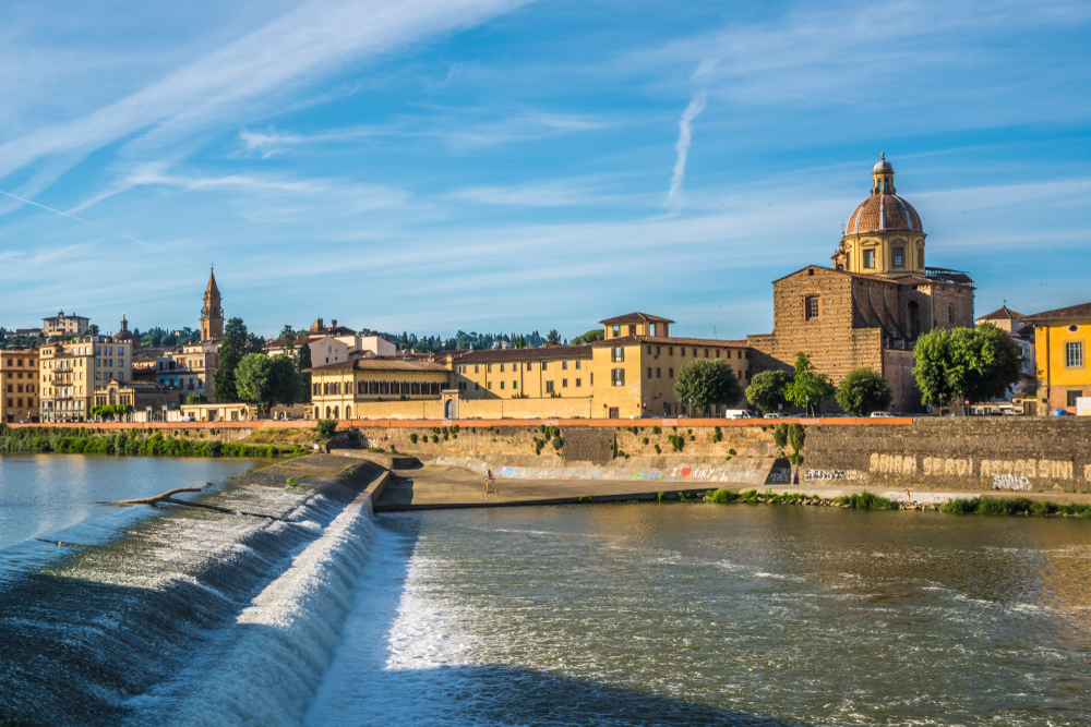San Frediano Church viewed across the river with a waterfall.