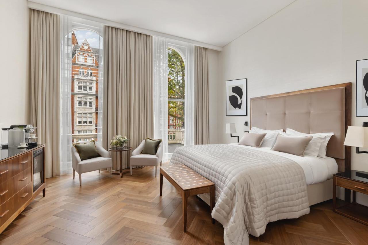 Beautiful room at The Queen's Gate Hotel with tall windows and a comfy bed.