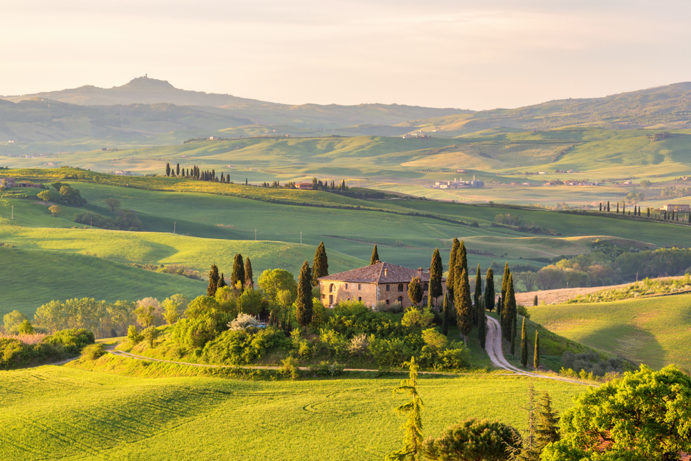A Tuscan villa nestled in the rolling hills of Tuscany at golden hour.