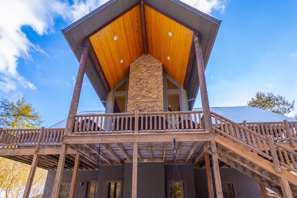 Exterior view of the impressive deck and outdoor fireplace of the Lazy Bear Lodge 