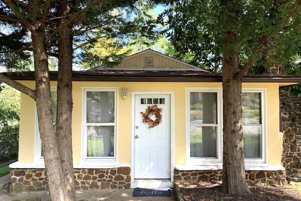 the charming yellow and stone exterior of this annapolis cottage