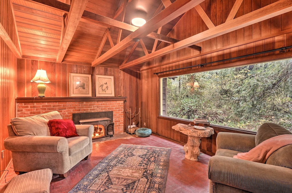 cozy living room and forest view beyond of the carlotta cabin, one of the best cabins in the pacific northwest