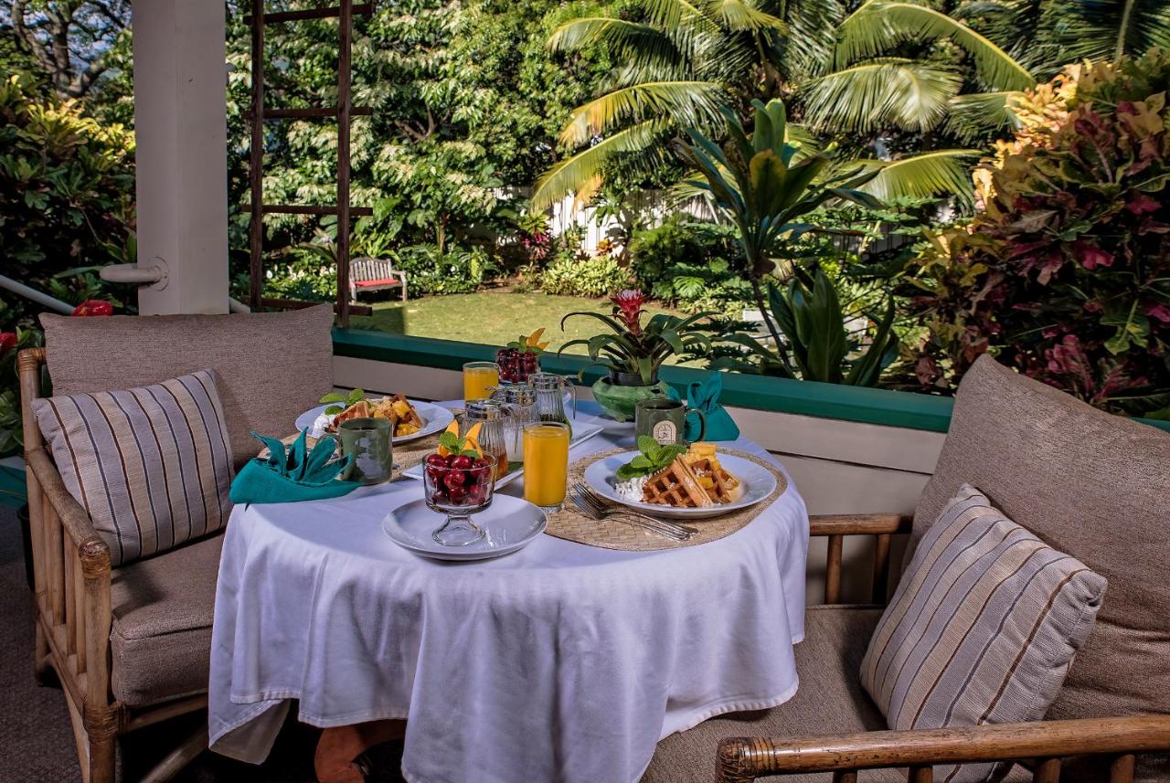 Breakfast spread on a patio overlooking a lush garden.