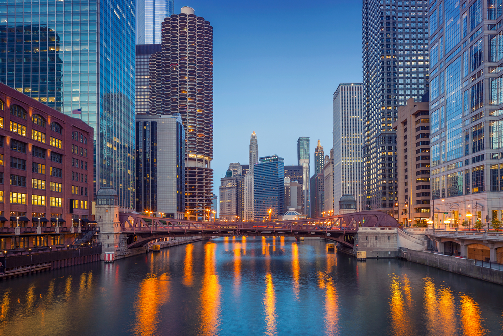 Twilight on the Chicago River with skyscrapers on both sides during a weekend getaway in the USA.