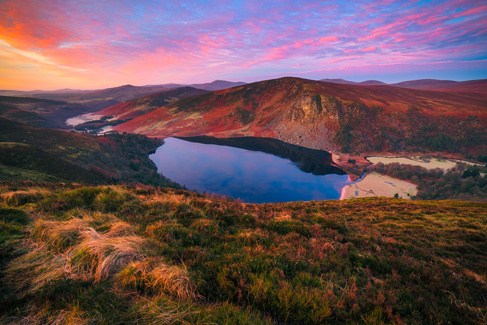 Sunset over a mountain lake during fall in Ireland.