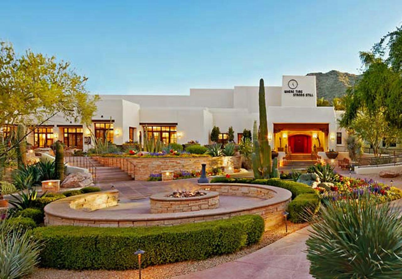 the well manicured grounds of the Camelback Inn with desert landscape and pueblo style buildings 