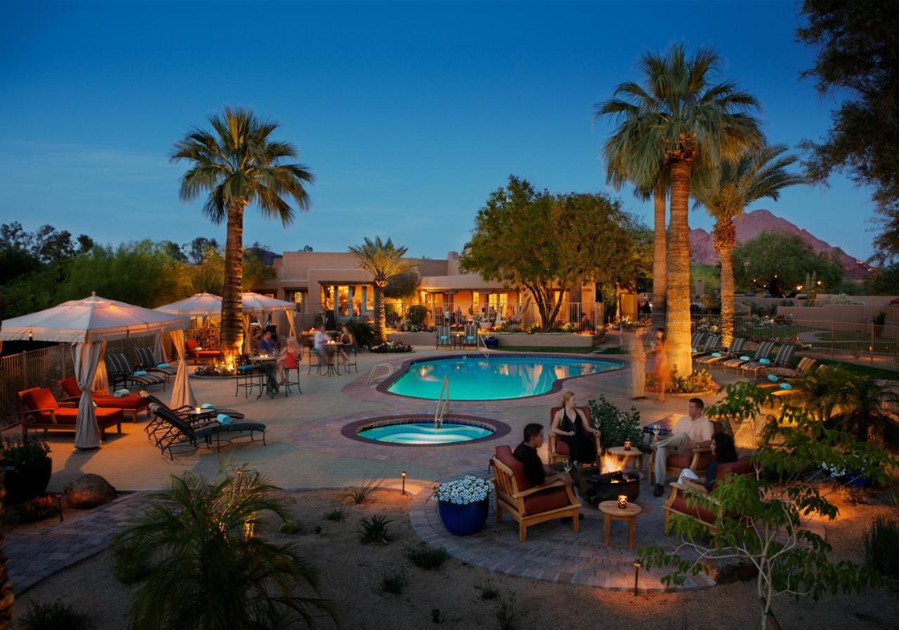 nighttime at the pool at the Hermosa Inn with people chatting by the fire pit near the Jacuzzi