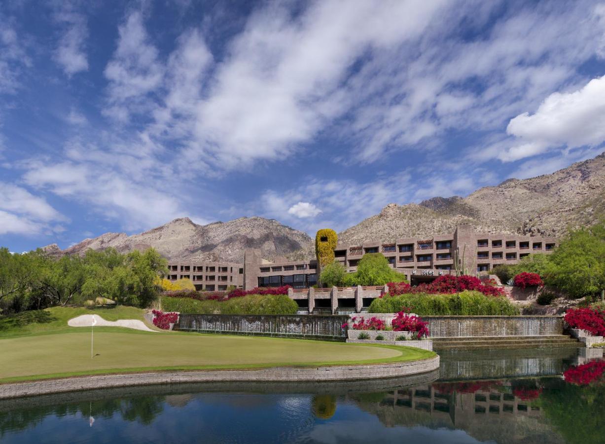 a small lagoon and one of the golf course holes in front of the Loews Ventana Canyon resort with mountains in the background
