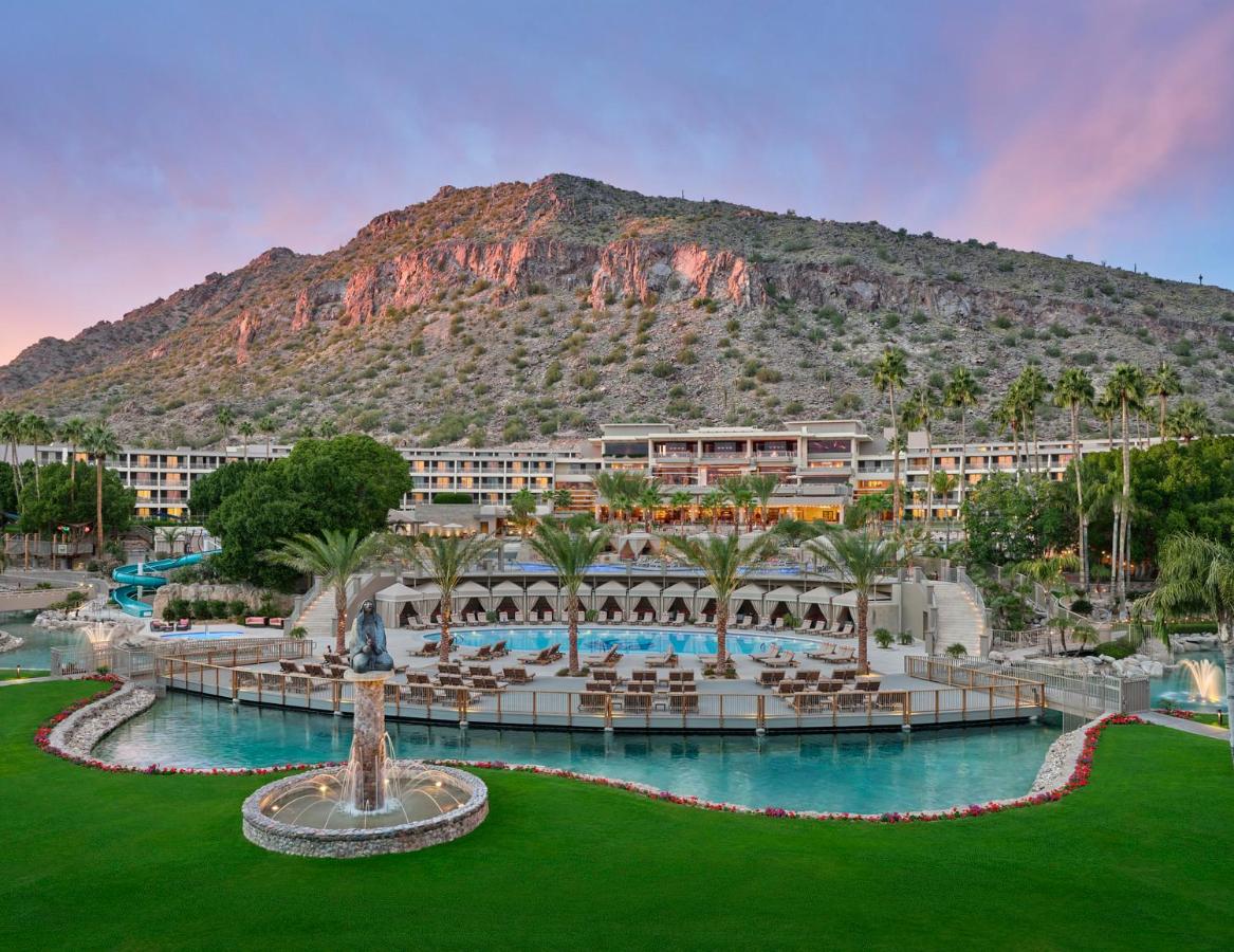 a zoomed out view of the pool and resort at The Phoenician with a mountain in the background