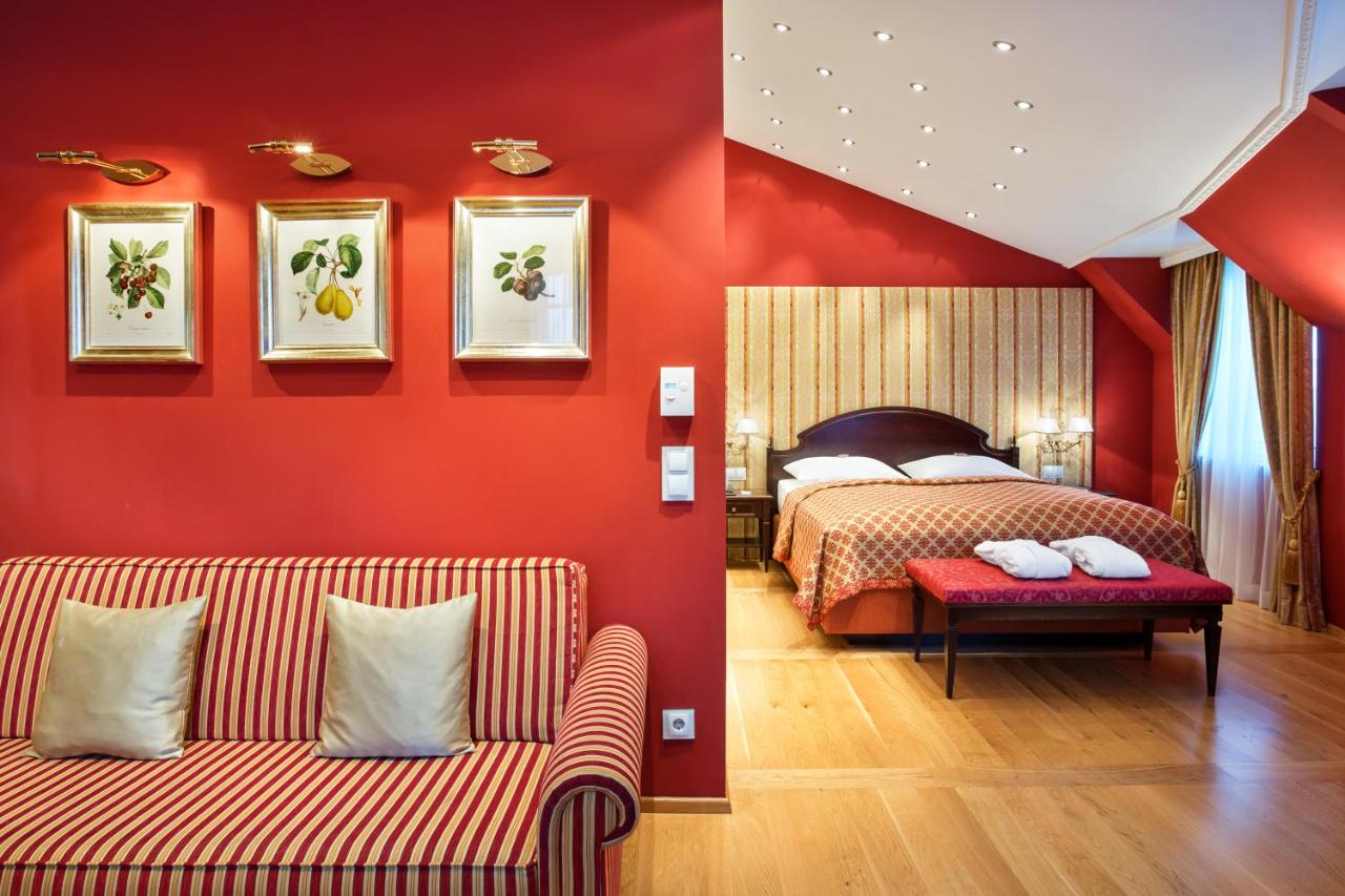 Red colored room with couch and bed.