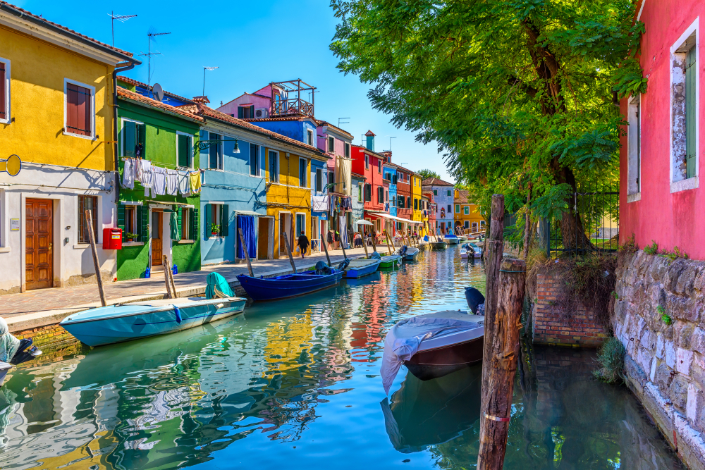 Small canal with boats and colorful buildings in Burano.