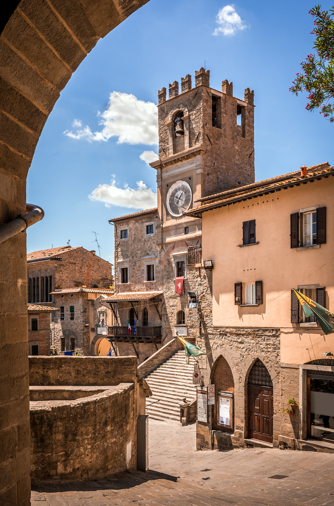 View of the bell tower and old buildings in Cortona, a day trip from Rome.