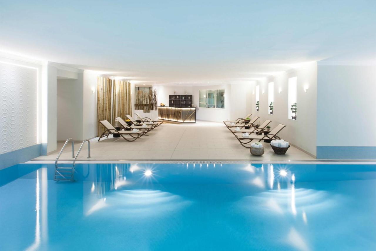 Pool and lounge chairs in a white painted room.