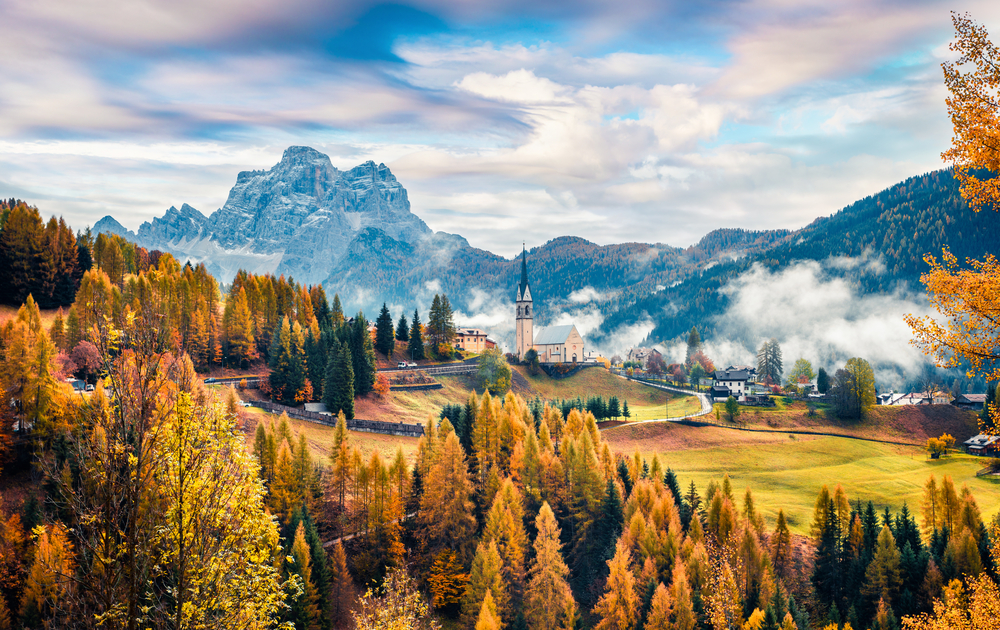 Fall scene with a church in the mountains of Italy.