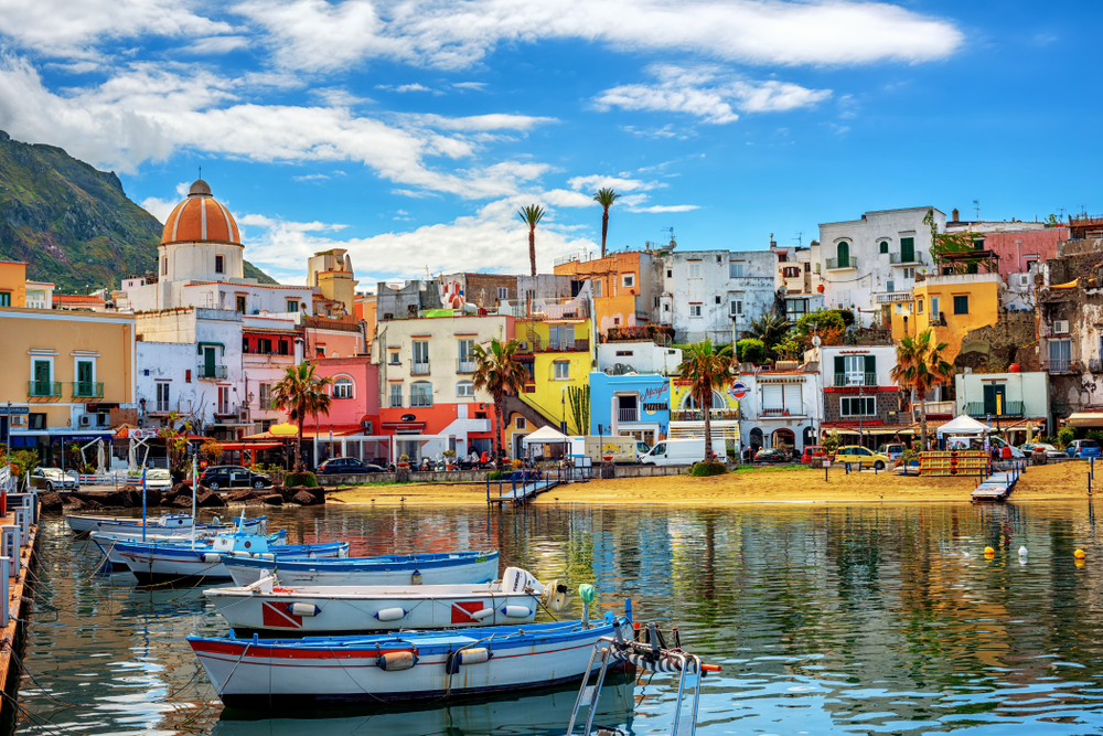 Boats docked near the beach and the colorful houses of Forio.