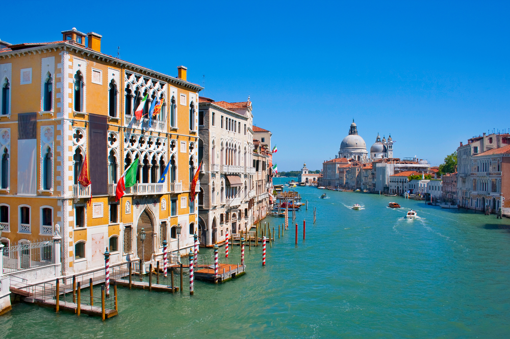 The yellow Gallerie Dell' Accademia building next to the Grand Canal in Venice.