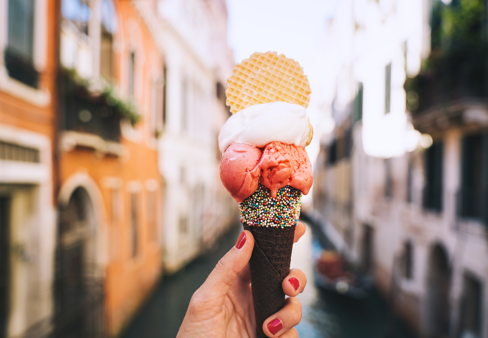 Hand holding a cone of gelato in Venice.