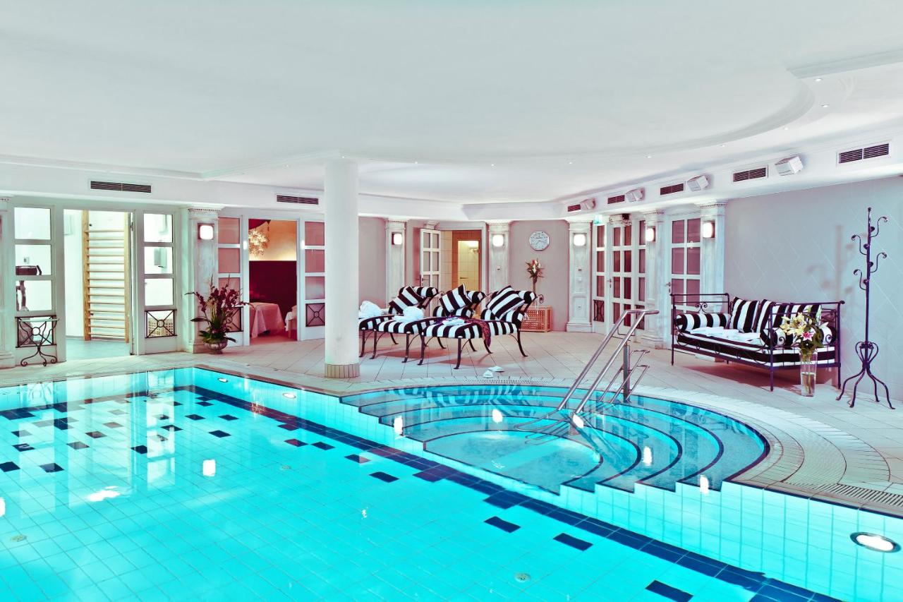 Pool area with comfy, lounge chairs at Louisa's Place.