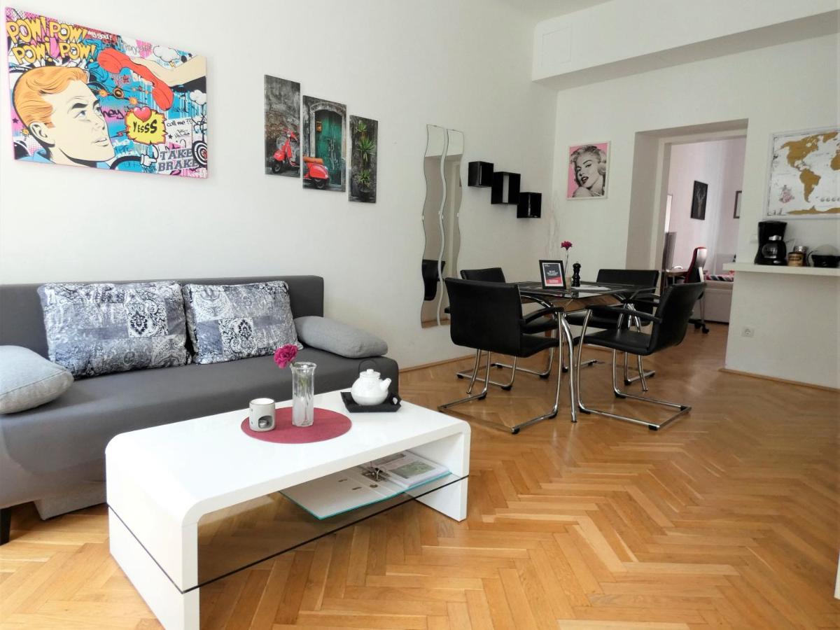 Living and dining area in the MSQ Belvedere apartment with wall art.