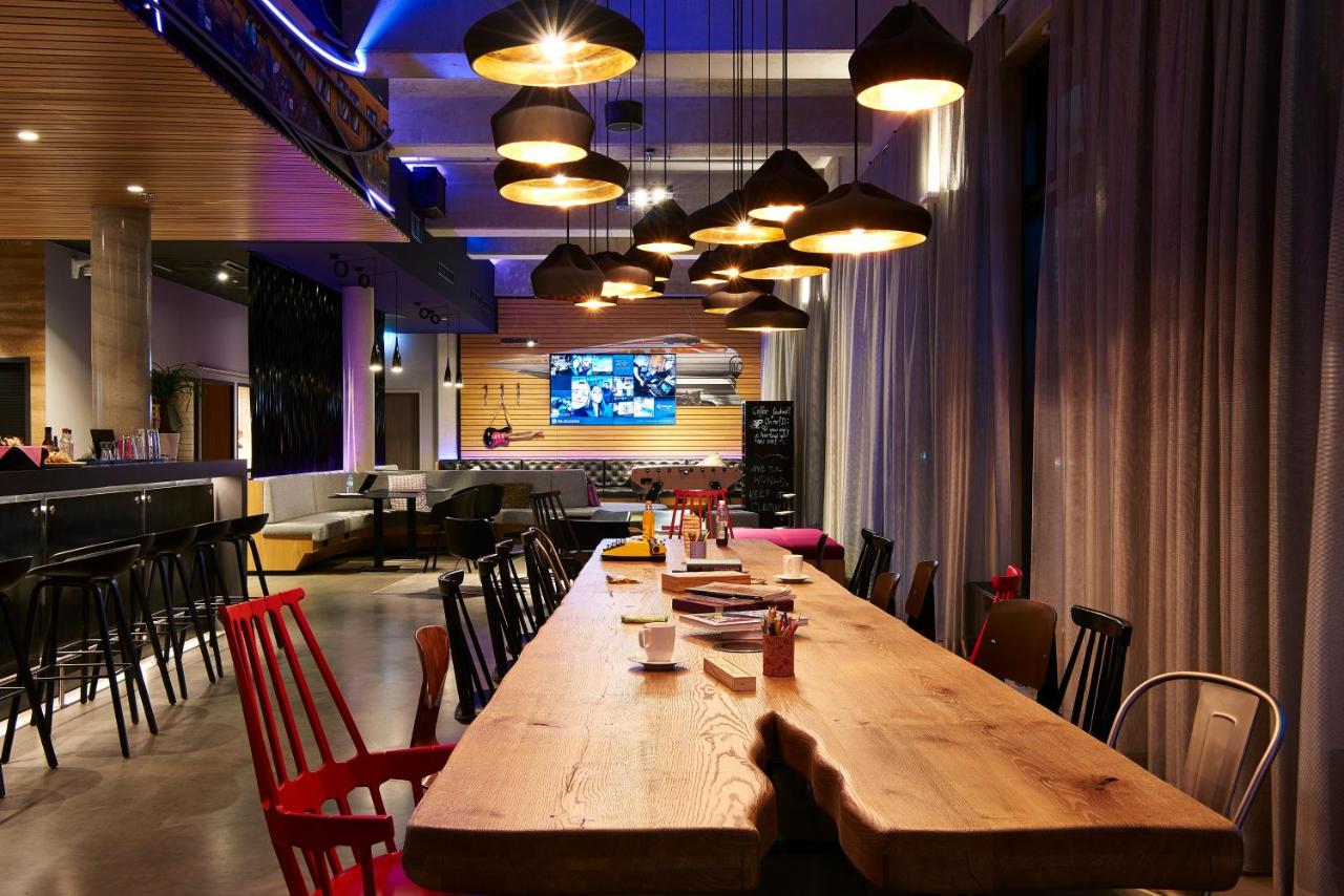 Natural wood table in the bar area of Moxy Berlin Ostbahnhof.