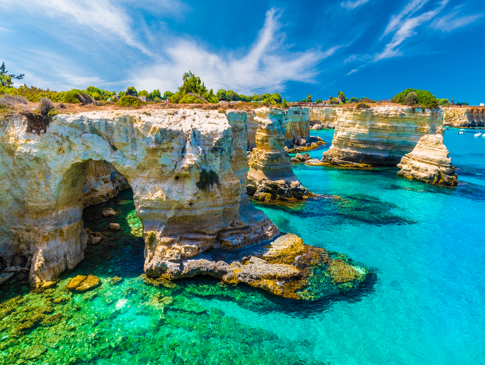 Rugged sea stacks and arches on the southern Italian coast.