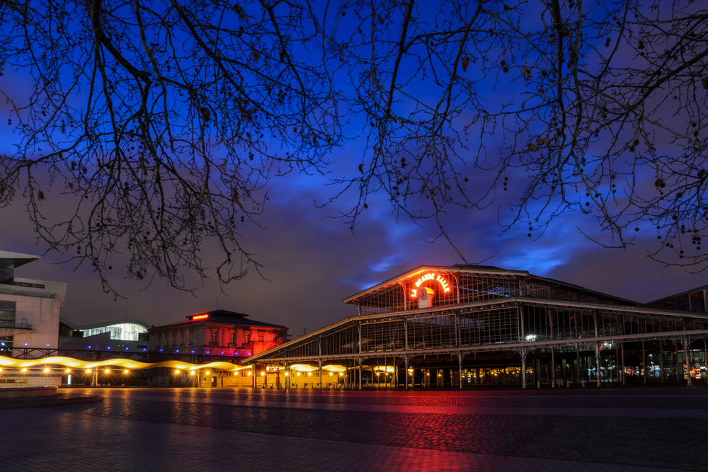 Nighttime in the Parc de la Villette featuring La Grande Halle.