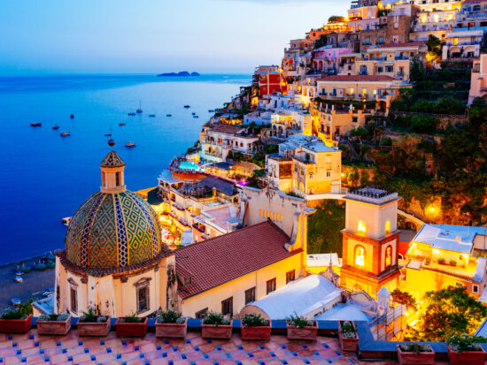 View of Positano at dusk on the coast after planning a trip to Italy