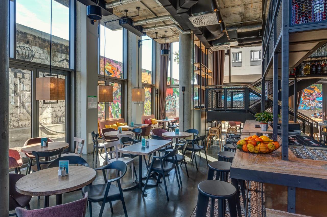 Modern dining area at the Schulz Hotel with views of the Berlin Wall out the window.