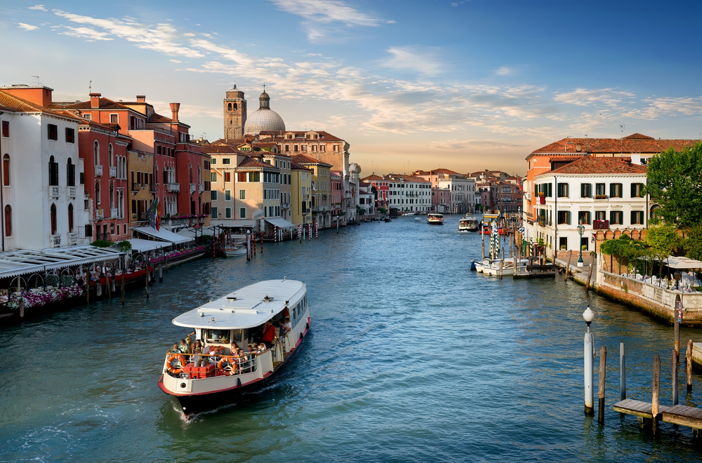 Vaporetto water taxi in the Grand Canal at golden hour.