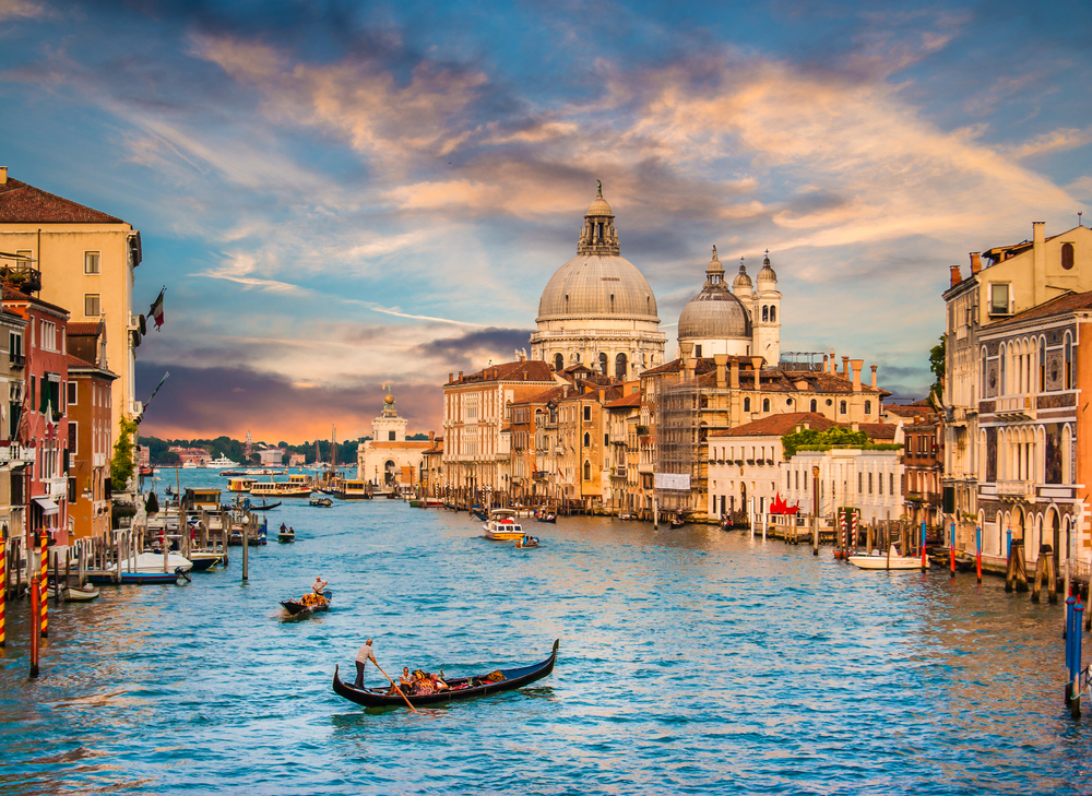 Sunset over the Grand Canal in in Venice with gondolas.