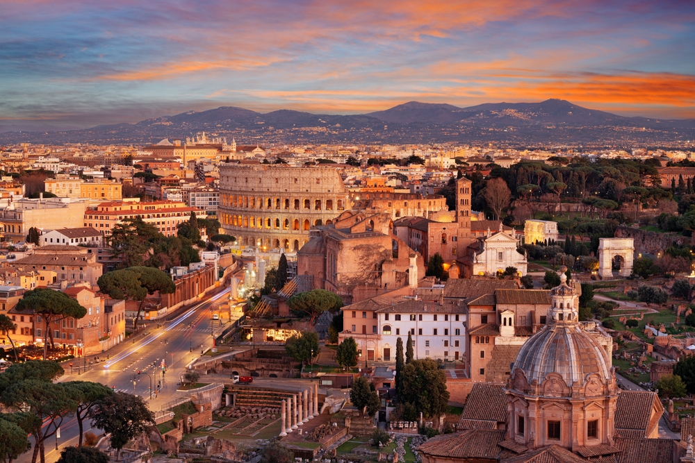 Sunset over the city of Rome featuring the Colosseum.