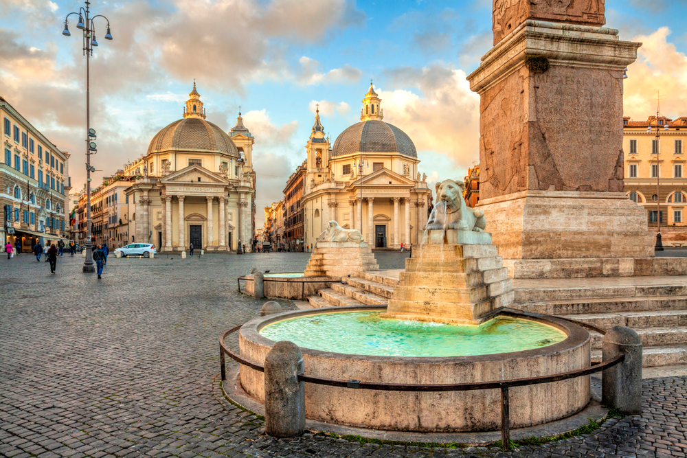 Piazza del Popolo with lion fountain and churches.