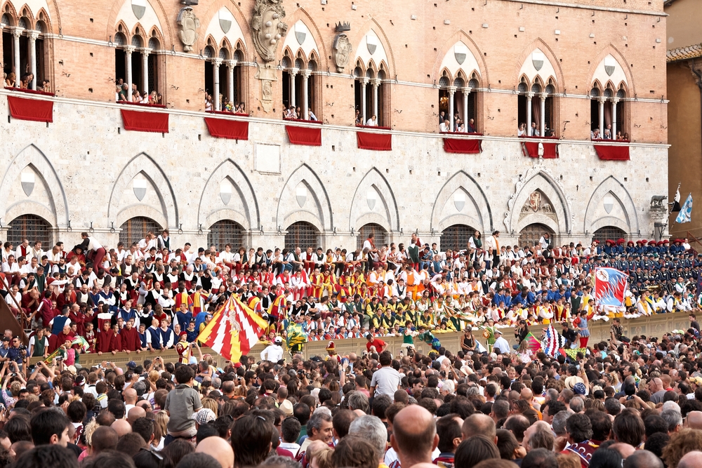 VIPs and Spectators in sienna town square await the start of the palio horse race