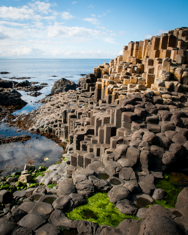 Stacked basalt columns next to the ocean.