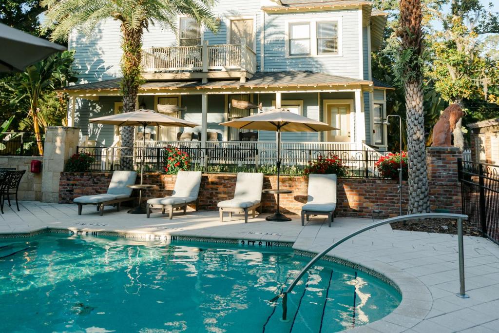 A small hotel pool in front of a historic building. This is one of the Adults-Only Resorts In The USA 