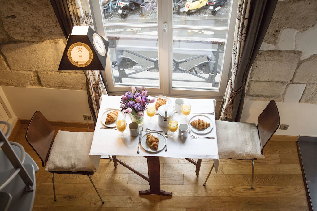 View of a beautiful croissant breakfast laid on a table in this amazing Paris studio apartment. This is one of the best airbnbs in France. 