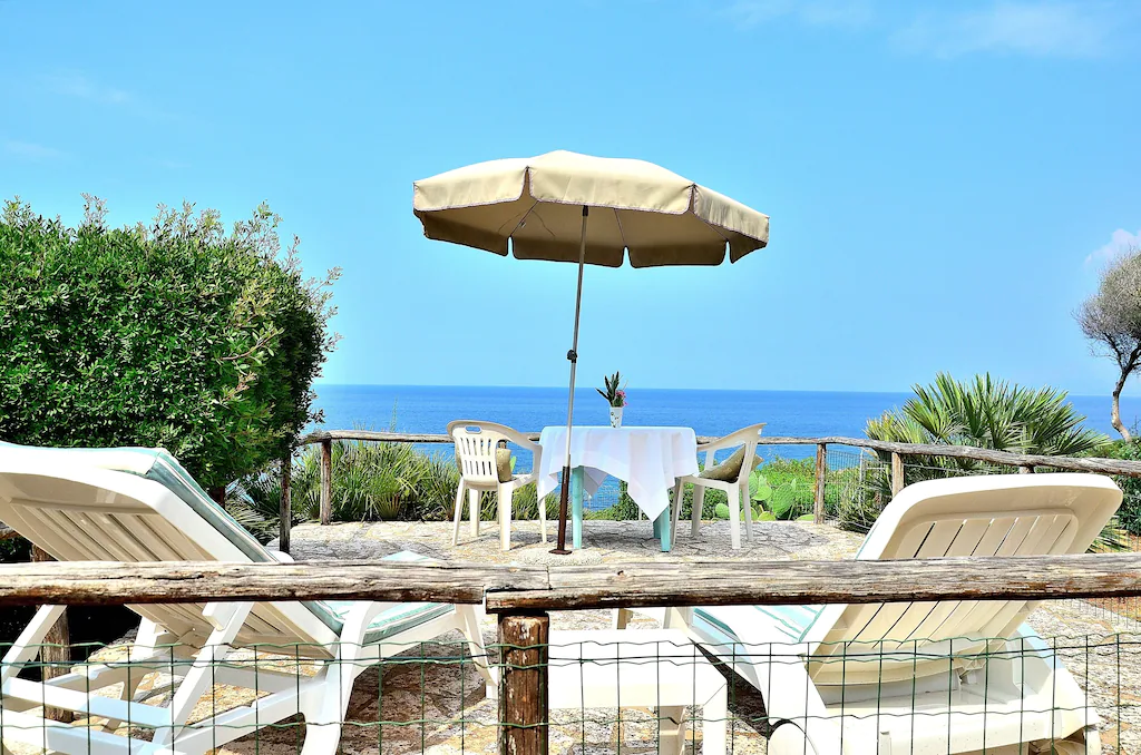 View of the beautiful ocean beyond the terrace of the Sicilian Cottage. This is one of the best airbnbs in Sicily.
